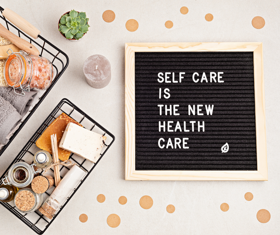 Self care is the new health care. Motivational quote on black letter board with variety of organic body and face care product
